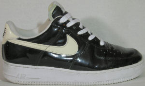 Nike Air Force I low-top, black patent leather with white SWOOSH