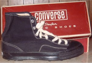 Side view of black high-top Converse "Chuck Taylor" football shoes: outside along with a partial view of the box top