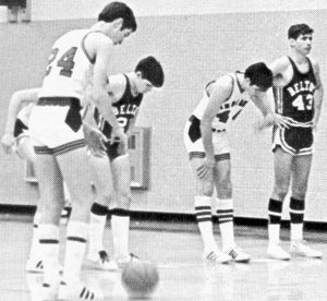 Basketball being played in vintage Chuck and Adidas Superstar shoes