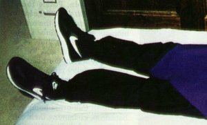 A picture from the "Heaven's Gate" mass suicide, showing off their black Nikes with a white SWOOSH A picture from the "Heaven's Gate" mass suicide, showing off their black Nikes with a white SWOOSH